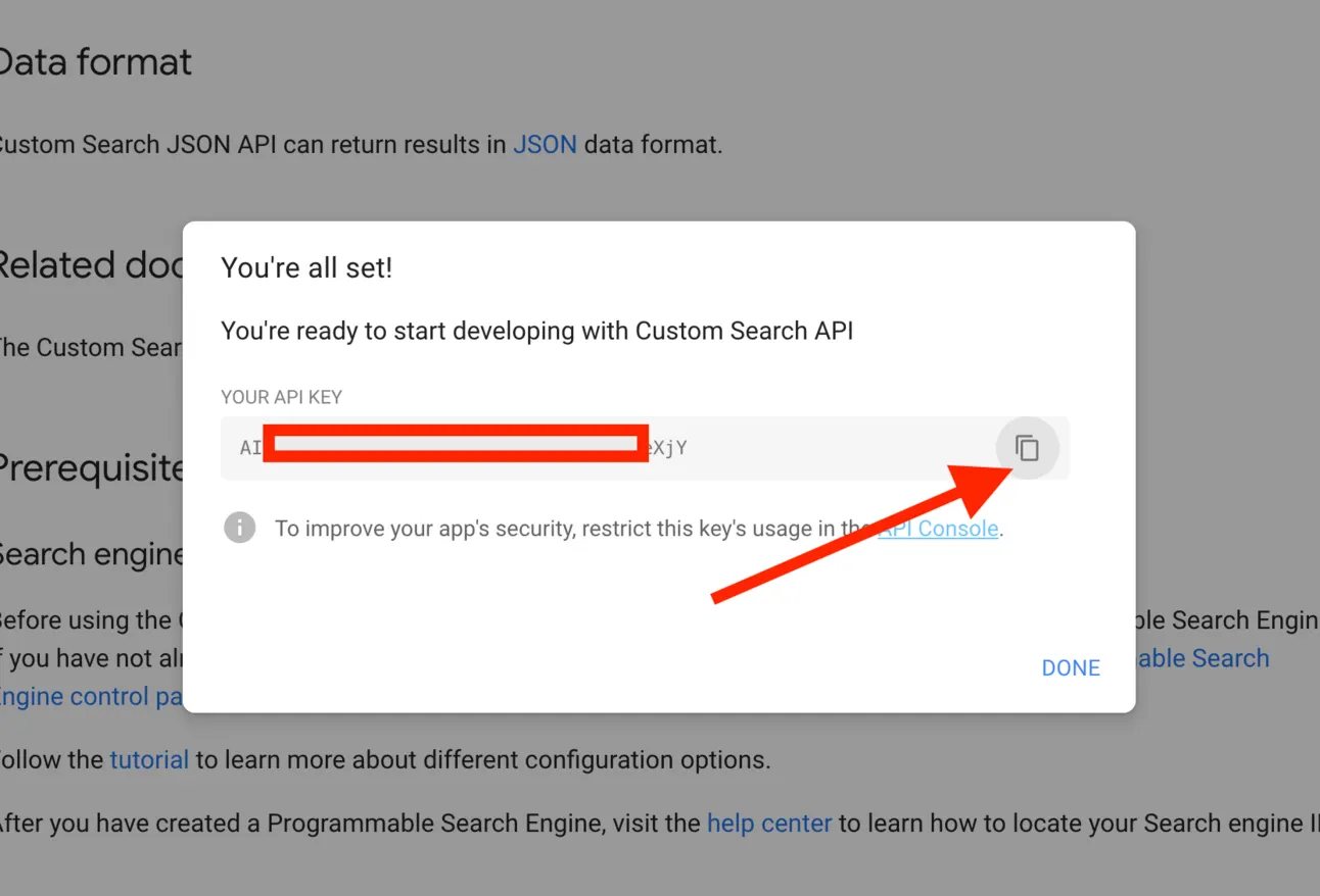 The Custom Search API key dialog with the key partly redacted and an arrow pointing at the copy button